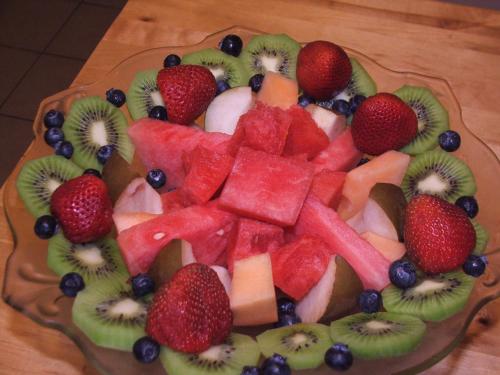 a plate of fruit on a wooden table at Oakland Cottage Bed and Breakfast in Asheville