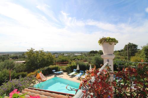 a villa with a swimming pool and a garden at Villa Belvedere in Ostuni