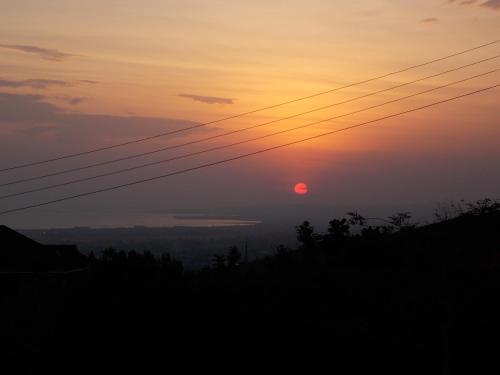 a sunset with the sun in the sky at Lago Resort - Best Views in Kisumu in Kisumu