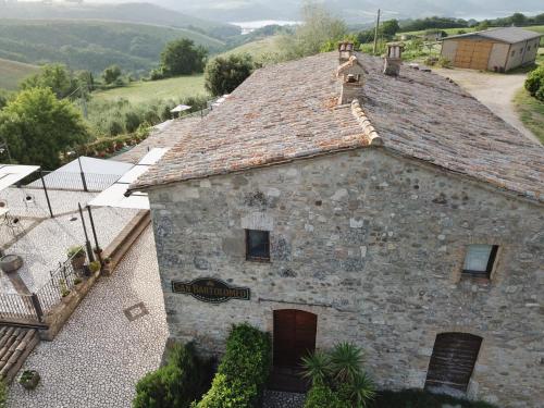 an old stone building with a tile roof at Agriturismo San Bartolomeo in Montecchio
