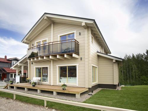 a house with a balcony on the side of it at Villa Saimaan Valo in Imatra