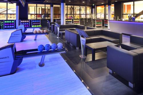 a bowling alley with blue balls on a table at Villa Saimaan Valo in Imatra