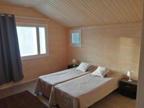 Llit o llits en una habitació de Villa Saimaan Valo