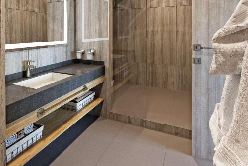 a bathroom with a sink and a shower at Wyndham Garden Astana in Astana