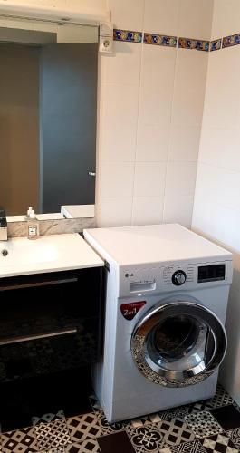 - un lave-linge dans la cuisine équipée d'un évier dans l'établissement Le petit vosgien, à Gérardmer