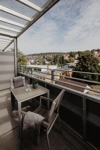 a balcony with a table and chairs and a view at Arivo Forchheim in Forchheim