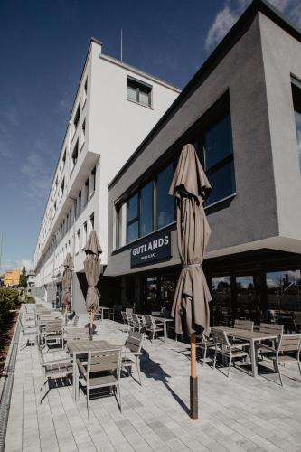 a group of tables and umbrellas in front of a building at Arivo Forchheim in Forchheim