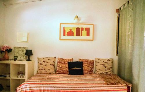 a bedroom with a bed with a striped blanket at Forest House casinha do Carvalhal in Vila Nova de Cerveira