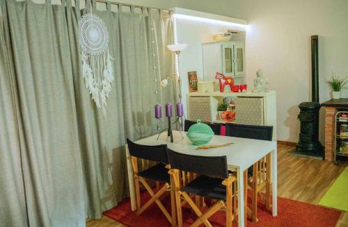 a room with a table and chairs and a mirror at Forest House casinha do Carvalhal in Vila Nova de Cerveira