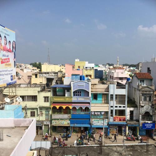 a group of buildings in a city with people at Jayaram Residency Tirupathi in Tirupati