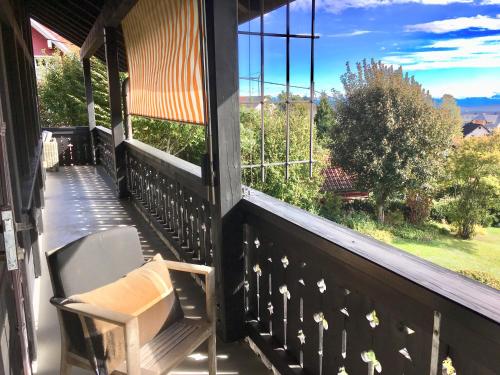 a porch with a chair and a view of a yard at Landhausvilla Strittberg 7 in Höchenschwand