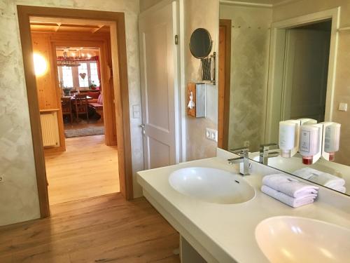 a bathroom with two sinks and a mirror at Landhausvilla Strittberg 7 in Höchenschwand