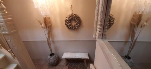 a room with three vases on the wall with flowers at Hendrika Apartments in Zandvoort