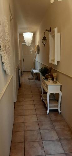 a hallway with a table and a chandelier at Hendrika Apartments in Zandvoort