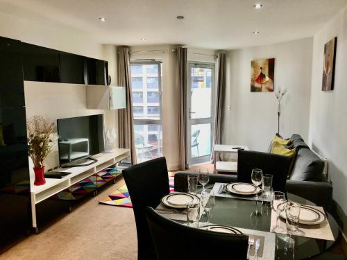 a living room with a dining table and a television at Marsh House in Bristol