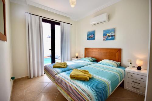 a bedroom with two beds with towels on them at Casa Vivien in Playa Blanca