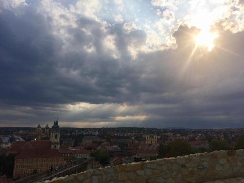 a view of a city under a cloudy sky at Forst-Ház Apartman in Eger