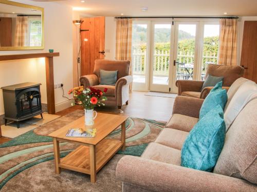 a living room with a couch and a coffee table at Conkers' Cottage in Church Stretton
