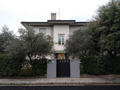 a white house with two utility boxes in front of it at Villa Beatrice in Brescia