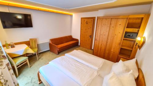 a bedroom with a bed and a table and a chair at Apart Marlen in Ischgl