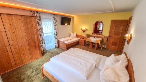 a bedroom with a white bed and a desk at Apart Marlen in Ischgl