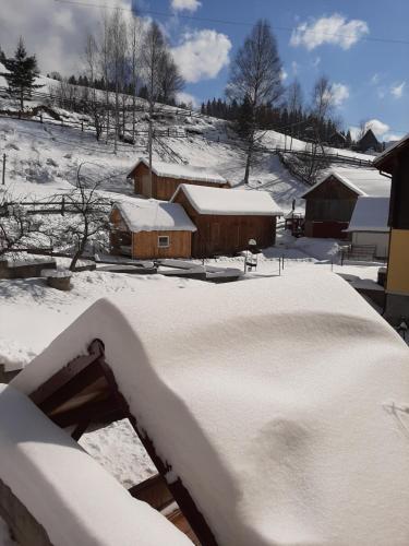 a yard covered in snow with buildings in the background at Barda in Vorokhta