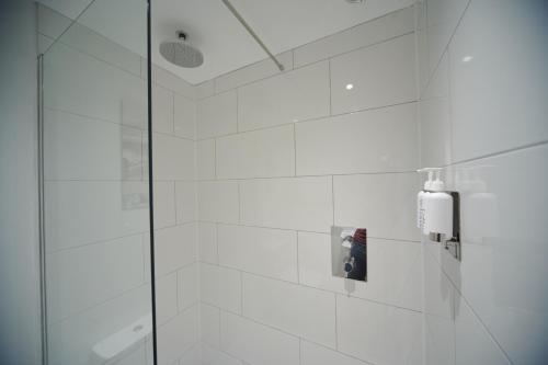 a bathroom with a shower with a glass door at Black Lion Inn in Leek