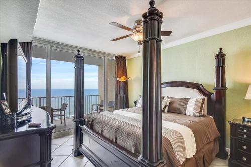 a bedroom with a bed and a balcony with the ocean at San Carlos Unit 902 in Gulf Shores