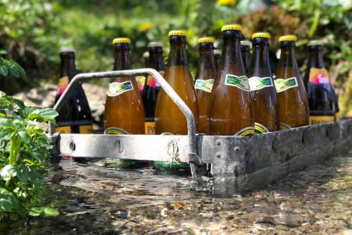a row of beer bottles in a container in the water at Ferienhaus Königsdorf - Urlaub im Tölzer Land in Königsdorf