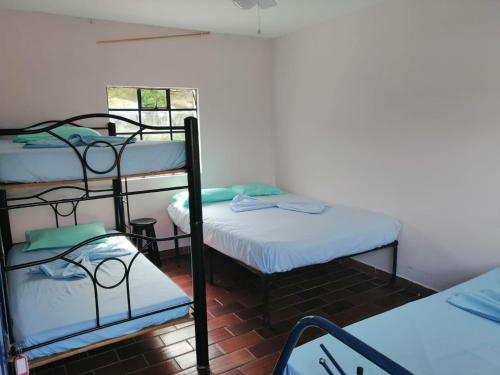 a room with three bunk beds in a room at Finca Campestre Piscina Privada Anapoima in Anapoima