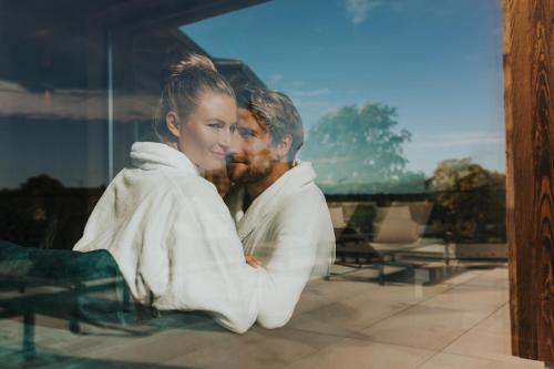 a man and a woman sitting next to each other at Ortner's Resort in Bad Füssing