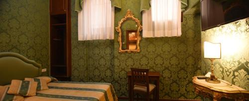 a room with a bed and a mirror at Hotel Marconi in Venice