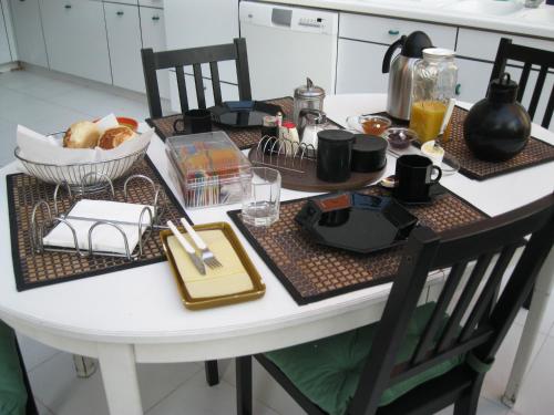a kitchen table with a breakfast table at B&B Middelheim in Antwerp