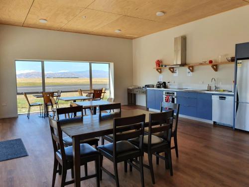 a kitchen and dining room with a table and chairs at Pukaki Air Lodge in Twizel