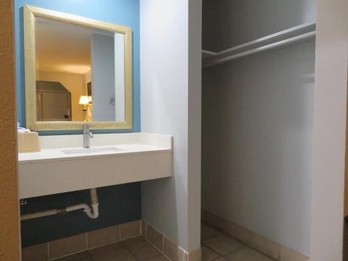 a bathroom with a sink and a mirror at Travel Inn Beaumont in Beaumont