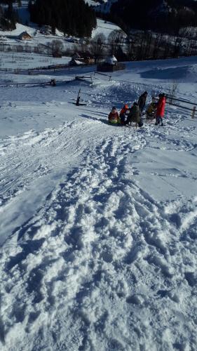 a group of people sitting in the snow at Bucovina mea in Breaza