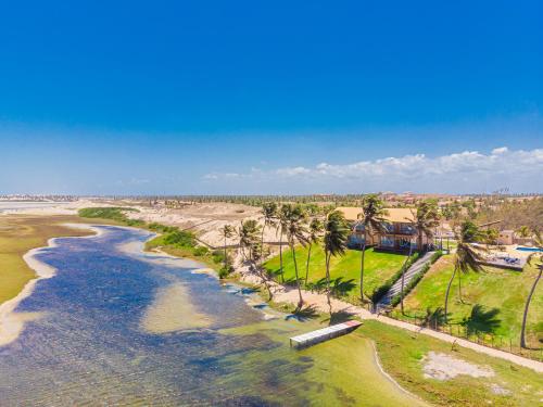 an aerial view of a beach with palm trees at Pousada Kiriri in Itarema