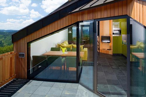 a room with sliding glass doors on a house at Apartamenty Malinka in Wisła