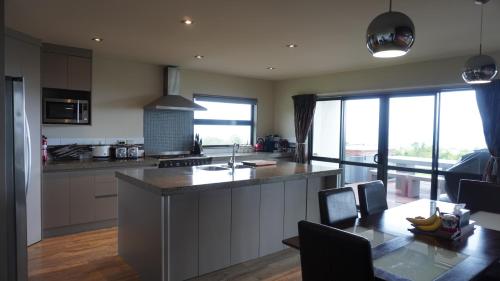 a kitchen with a large island in the middle at White House in Paraparaumu