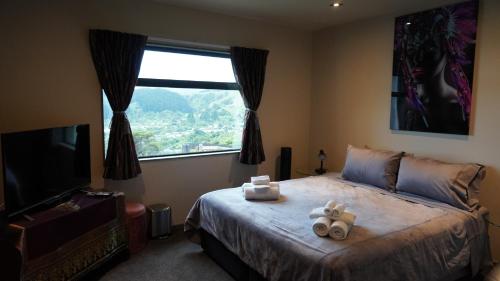 a bedroom with a bed with a teddy bear on it at White House in Paraparaumu