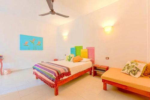 a bedroom with a bed and a desk at Vainilla Bed and Breakfast Mexico in Playa del Carmen
