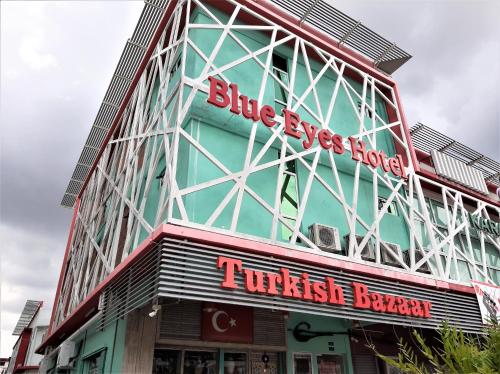 a building with a turkish brewery sign on it at Blue Eyes Hotel in Kepala Batas