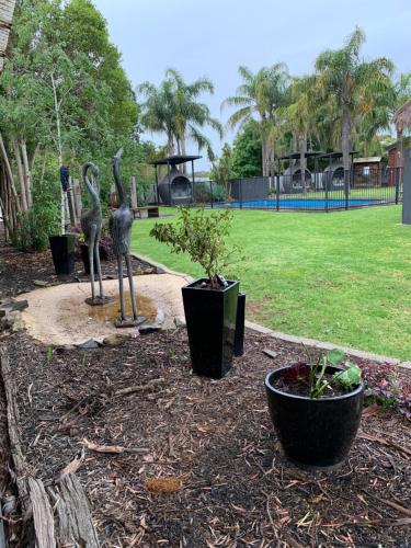 a statue of two birds in a park at Federation Motel Resort - Corowa in Corowa