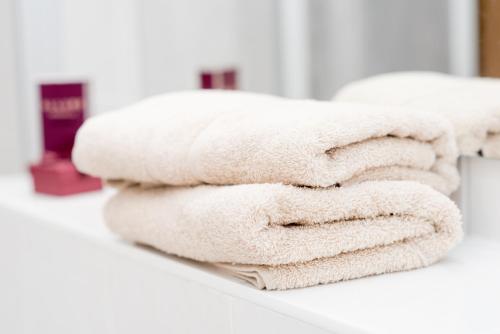 einen Stapel Handtücher auf einer Theke im Bad in der Unterkunft Stilvolle 1-Raum-Wohnung zentral, ruhig gelegen in Dresden