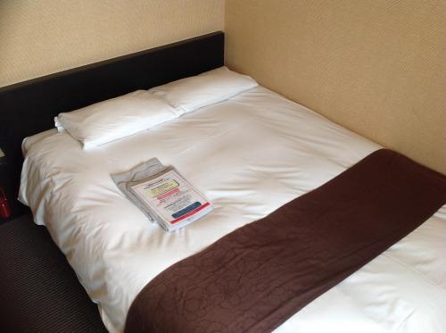 Postel nebo postele na pokoji v ubytování Hotel Crown Hills Kokura