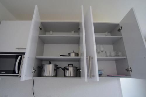 a kitchen with two pots and a microwave at Apartmány Karviná in Karviná