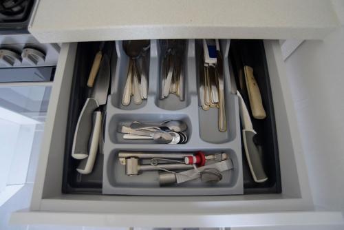 a drawer filled with utensils in a kitchen at Apartmány Karviná in Karviná