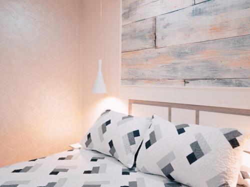 a bedroom with a bed and a wooden wall at Hotel Los Toreros in Tordesillas