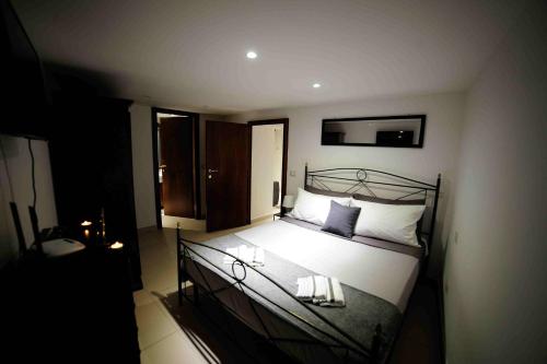 a bedroom with a bed with white sheets and pillows at La Casetta di Anna in Narni