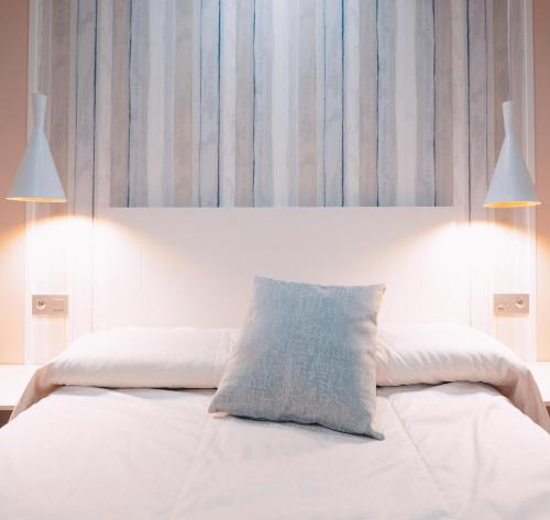 a bedroom with a bed with a pillow on it at Hotel Los Toreros in Tordesillas